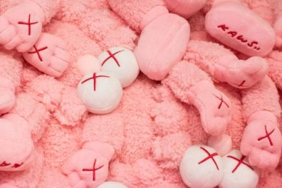 Pink plush KAWS toys with signature X eyes on display at Moco Museum Amsterdam
