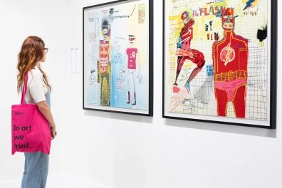 Visitor viewing Basquiat's superhero-themed artworks at Moco Museum Barcelona