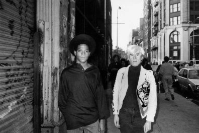 Black-and-white photo of Jean-Michel Basquiat and Andy Warhol.