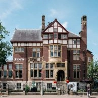 Exterior view of historic building housing Moco Museum Amsterdam.